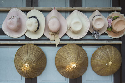 Hats hanging by bamboos