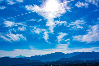 Low angle view of mountains against blue sky