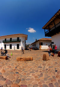 People in front of building against sky