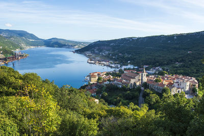 High angle view of townscape by sea