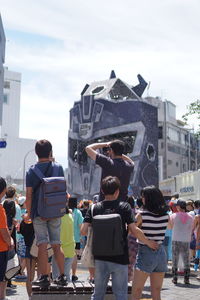 Rear view of people on street in city