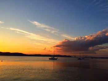 Boat in sea at sunset