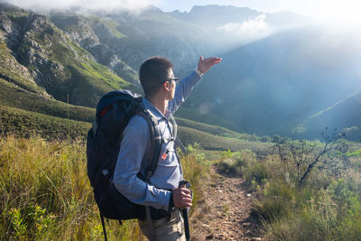 Man standing against mountain range