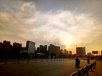 Men in city against sky