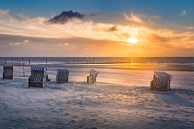 Sunset view on a beach with beach chairs in norderney, germany