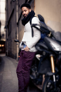 Portrait of young man standing in city
