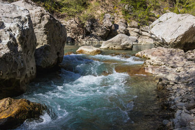 View of river flowing through rocks