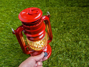 Close-up of hand holding fire hydrant on field