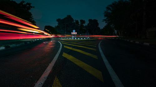 Light trails on road in city at night