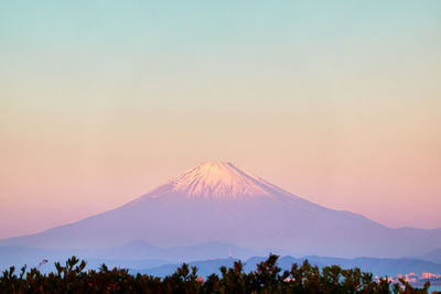 Scenic view of snowcapped mountains against sky during sunrise