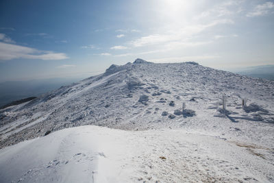 Scenic view of snow covered mountain against sky