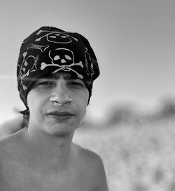 Portrait of young man standing against sky