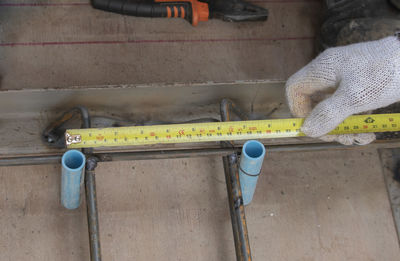 High angle view of man working on metal wall