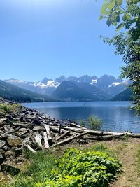 Scenic view of lake against clear blue sky