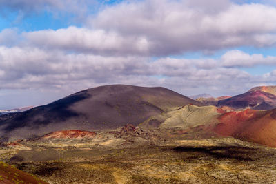 View of volcanic landscape against cloudy sky