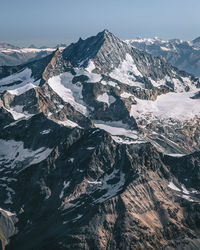 Aerial view of snowcapped mountains against sky