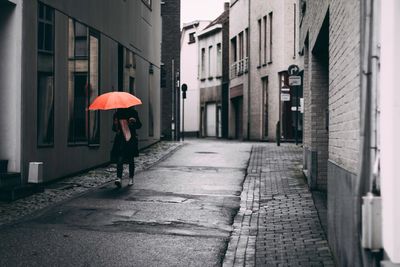 Woman walking in rain