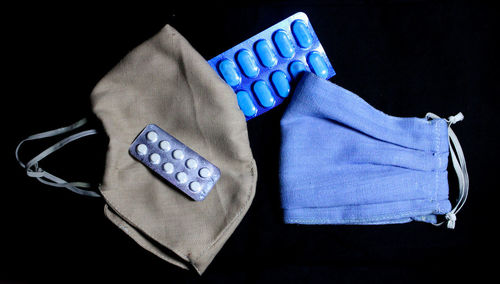 High angle view of blue colored pencils against black background
