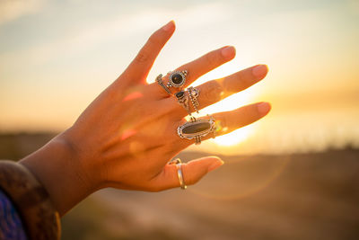 Female hand touching sun light on beach