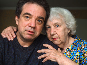Close-up portrait of mother with son at home