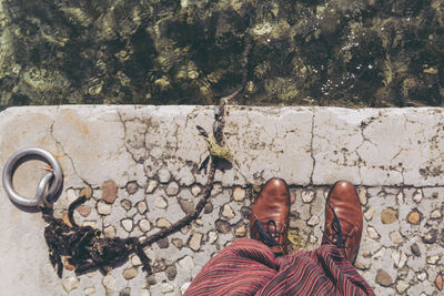 Low section of woman standing on tiled floor