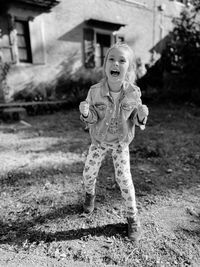 Portrait of young woman standing on field