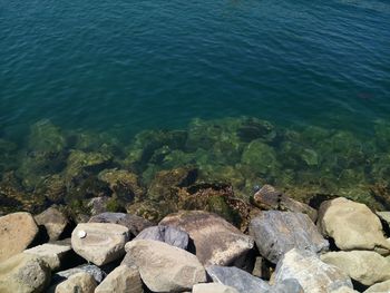 High angle view of rocks by sea