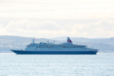 Ship sailing on sea against sky