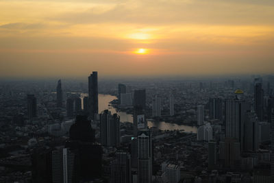 Cityscape against sky during sunset