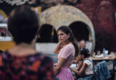 Side view of thoughtful woman standing outdoors