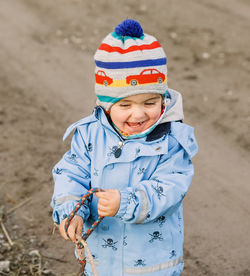 Boy wearing hat standing on land