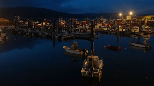 High angle view of illuminated harbor in city at night