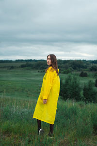 Man standing on yellow field against sky