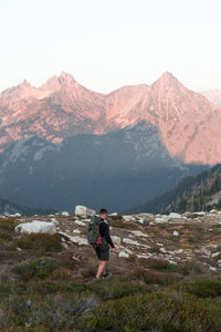 Full length of man standing on mountain against sky