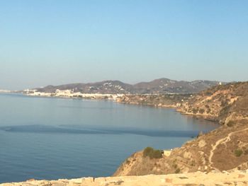 View of calm beach against blue sky