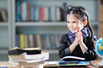 Smiling girl looking away sitting at classroom