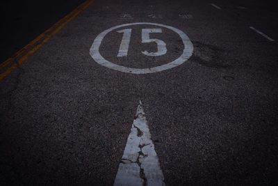 High angle view of road sign on street in city