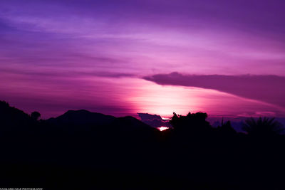 Scenic view of silhouette mountains against sky at sunset