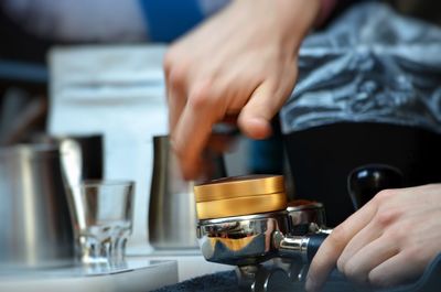 Cropped image of hand holding coffee cup