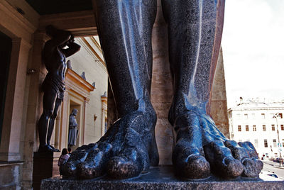 Low section of man standing by sculpture