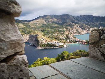 Scenic view of sea and mountains against sky