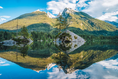 Scenic view of lake by mountains against sky