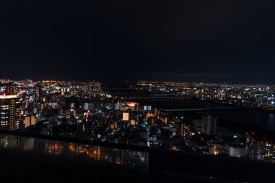 High angle view of illuminated buildings in city at night