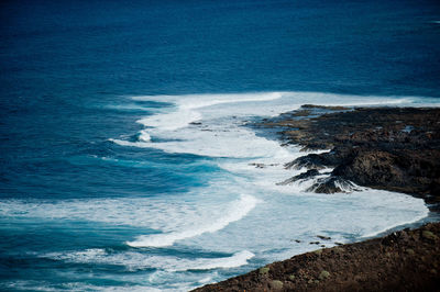 Scenic view of sea against blue sky