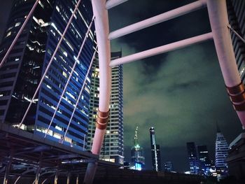 Low angle view of illuminated factory against sky at night