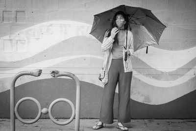 Woman standing against the wall