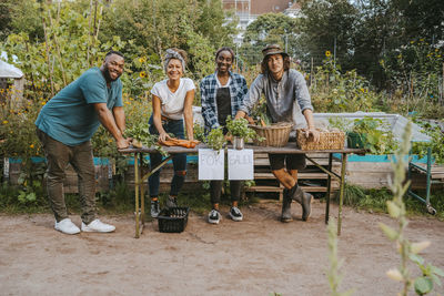 Portrait of male and female volunteers in farmer's market