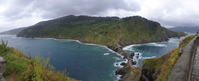 Panoramic view of sea and mountains against sky