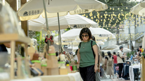 Portrait of smiling woman standing in market