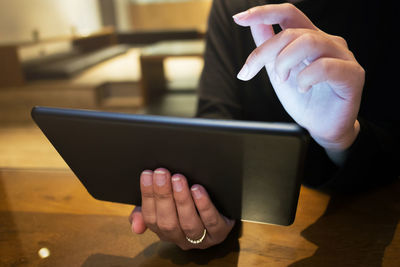 Midsection of man using mobile phone